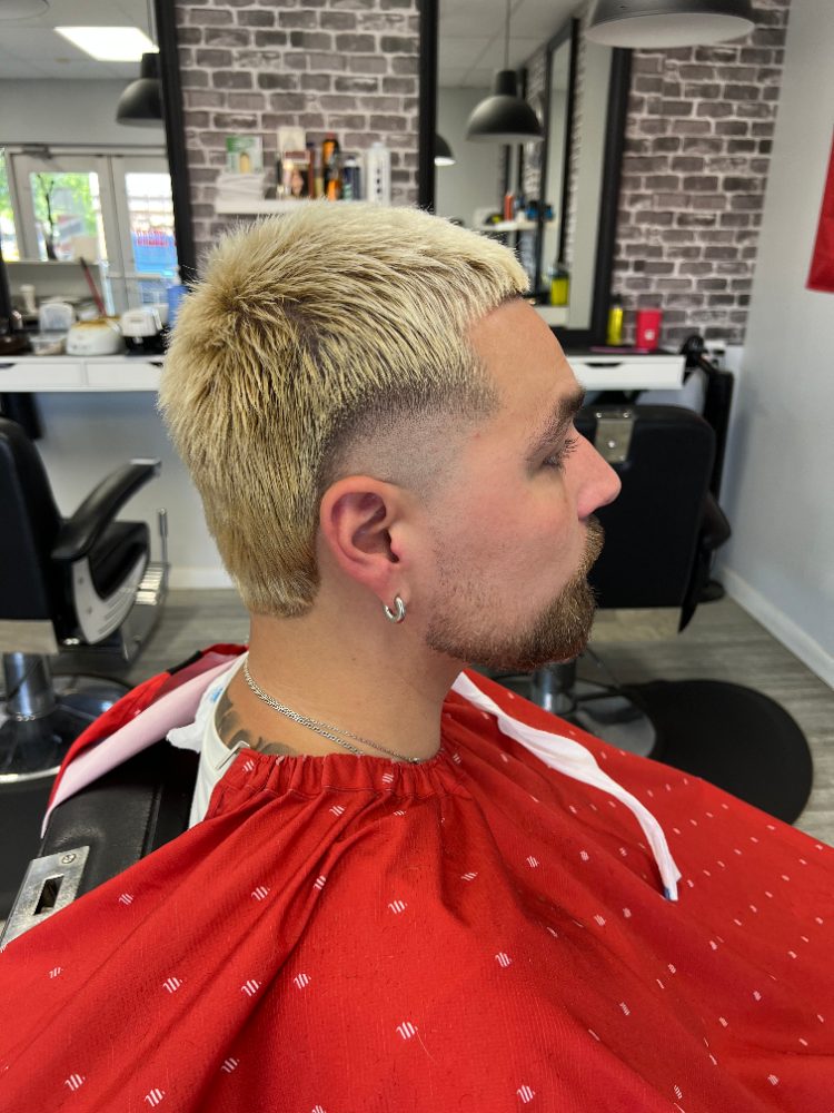 Blond textured cut with a skin fade and beard