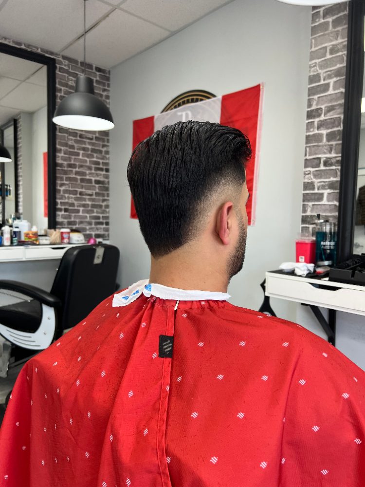 Back view of a skin fade with a styled top